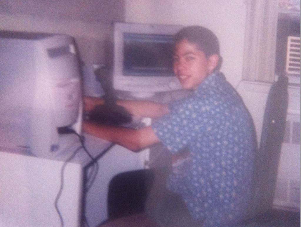 A vintage photo from the 1990s showing someone in a polka dot shirt sitting at a desk with a CRT monitor and a Compaq Presario computer